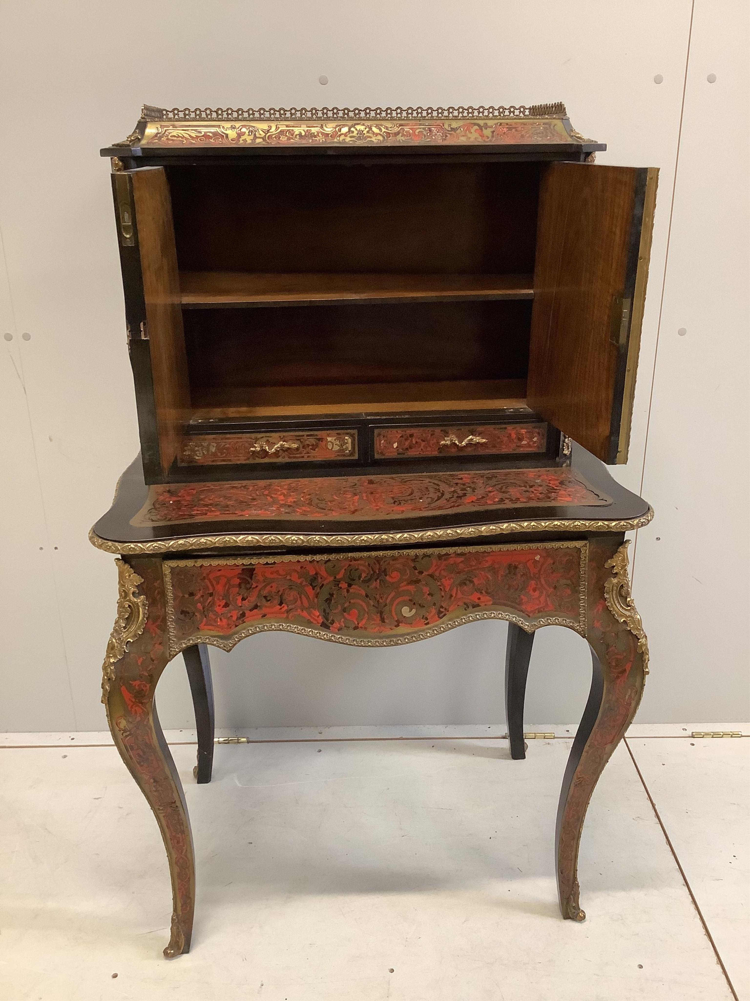 A 19th century French ebonized Boulle bonheur du jour, width 78cm, depth 54cm, height 128cm. Condition - fair to good, some minor losses and raised cut brass work.